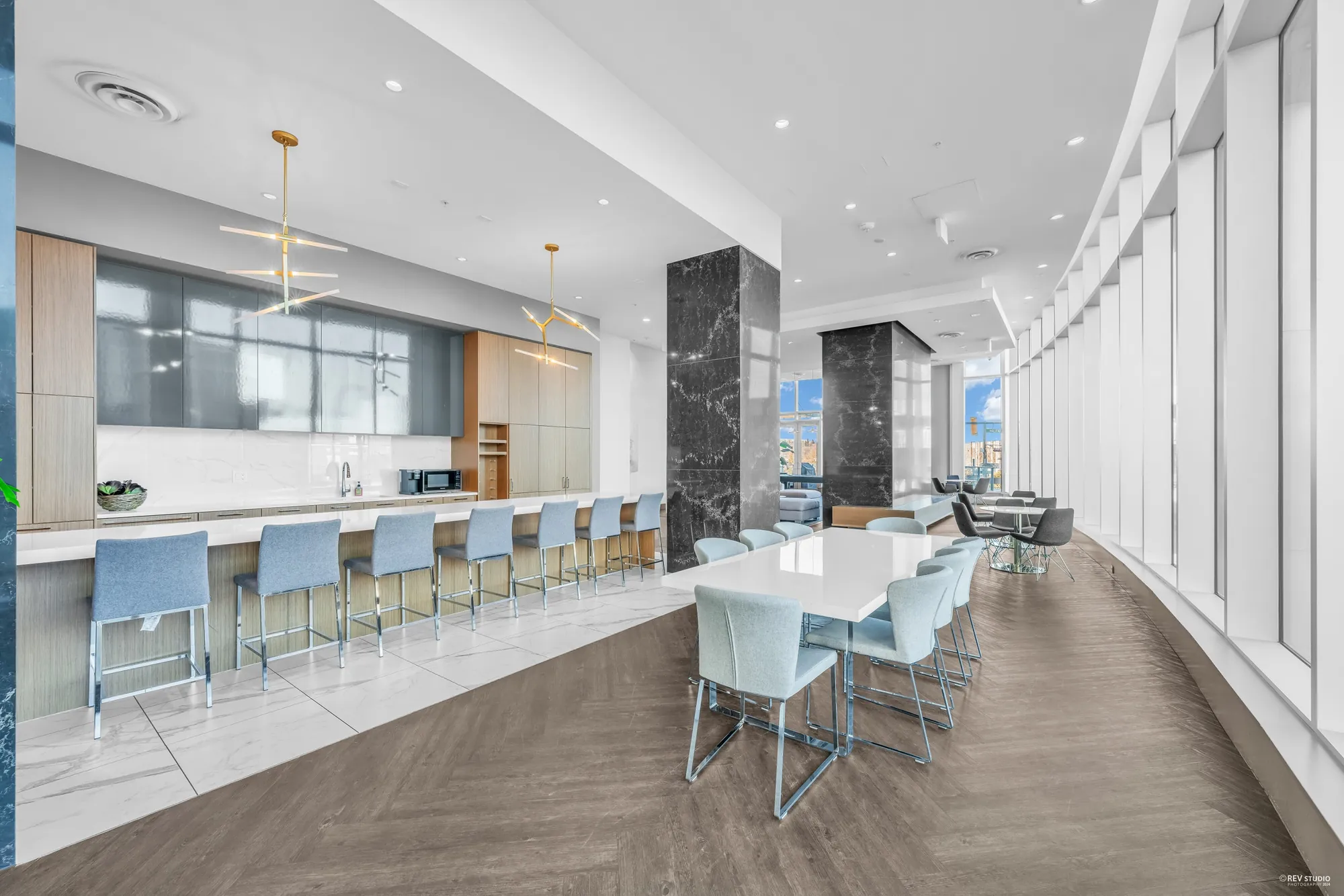 The party kitchen with a long island, bar stools and a dining table