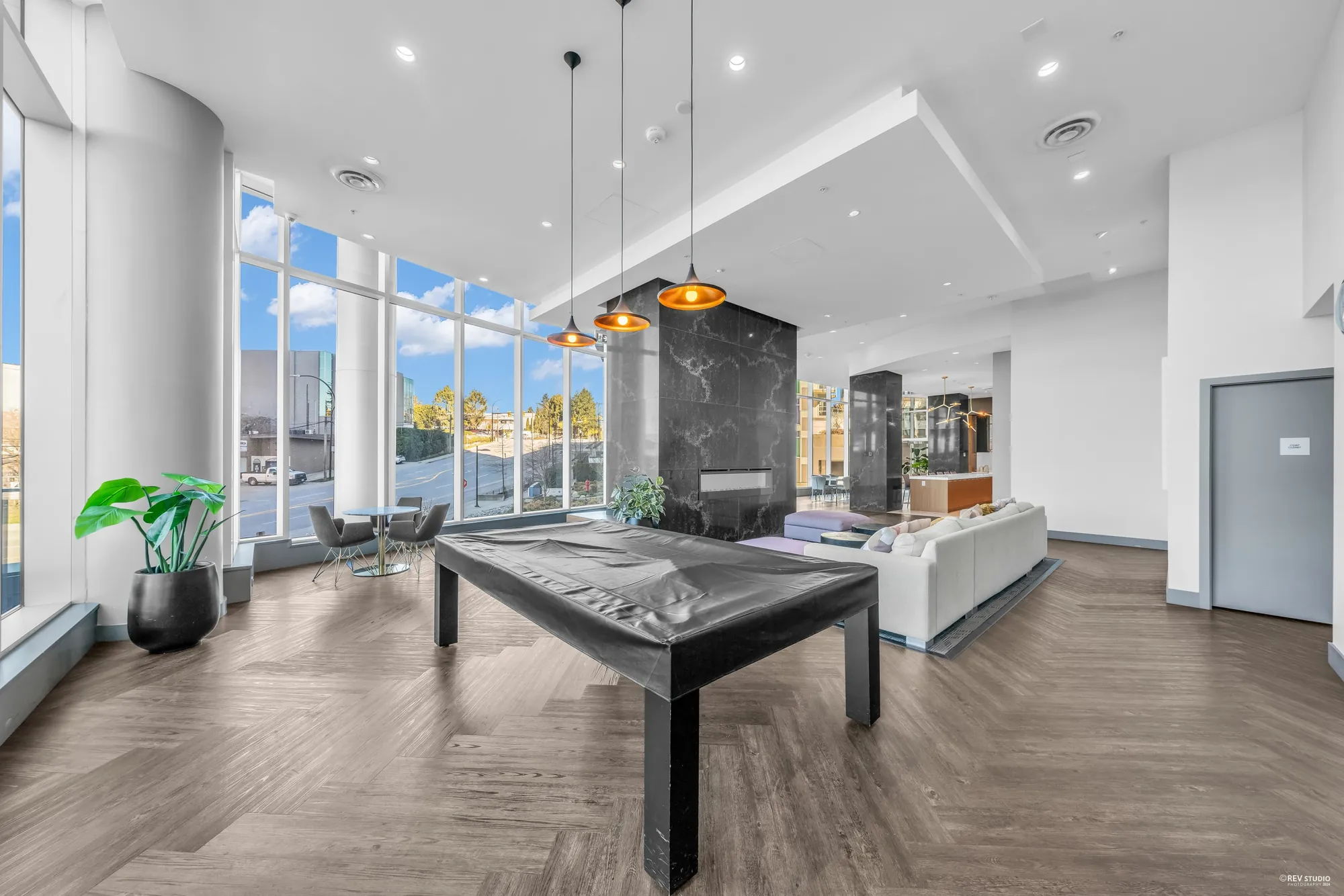 The games room with a pool table and seating by the windows