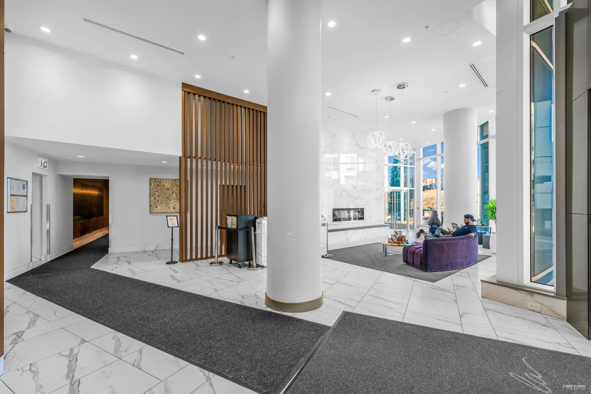 The lobby with marble floors, a wood screen and a seating area