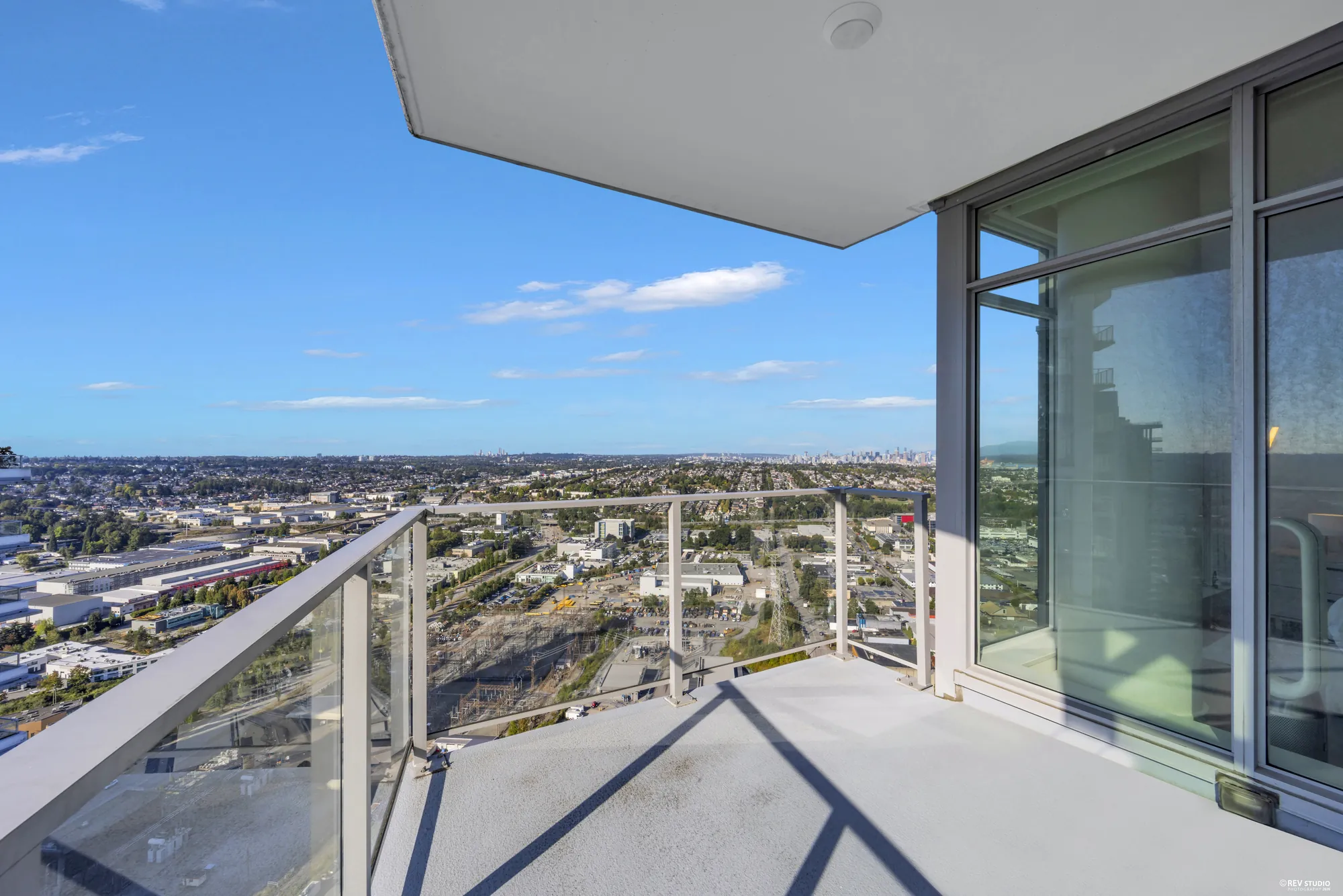 The balcony with a glass rail, looking out over the city