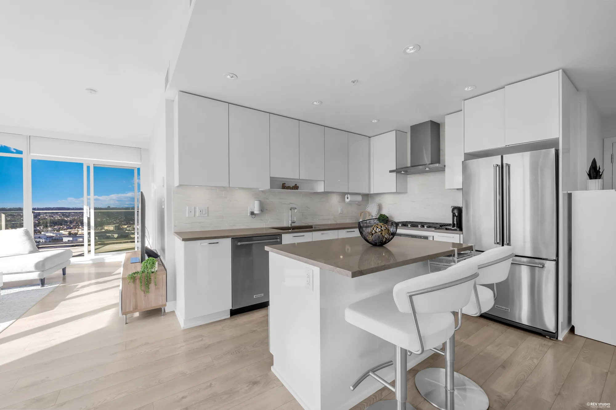 The kitchen from the living room, with the island and the window beyond