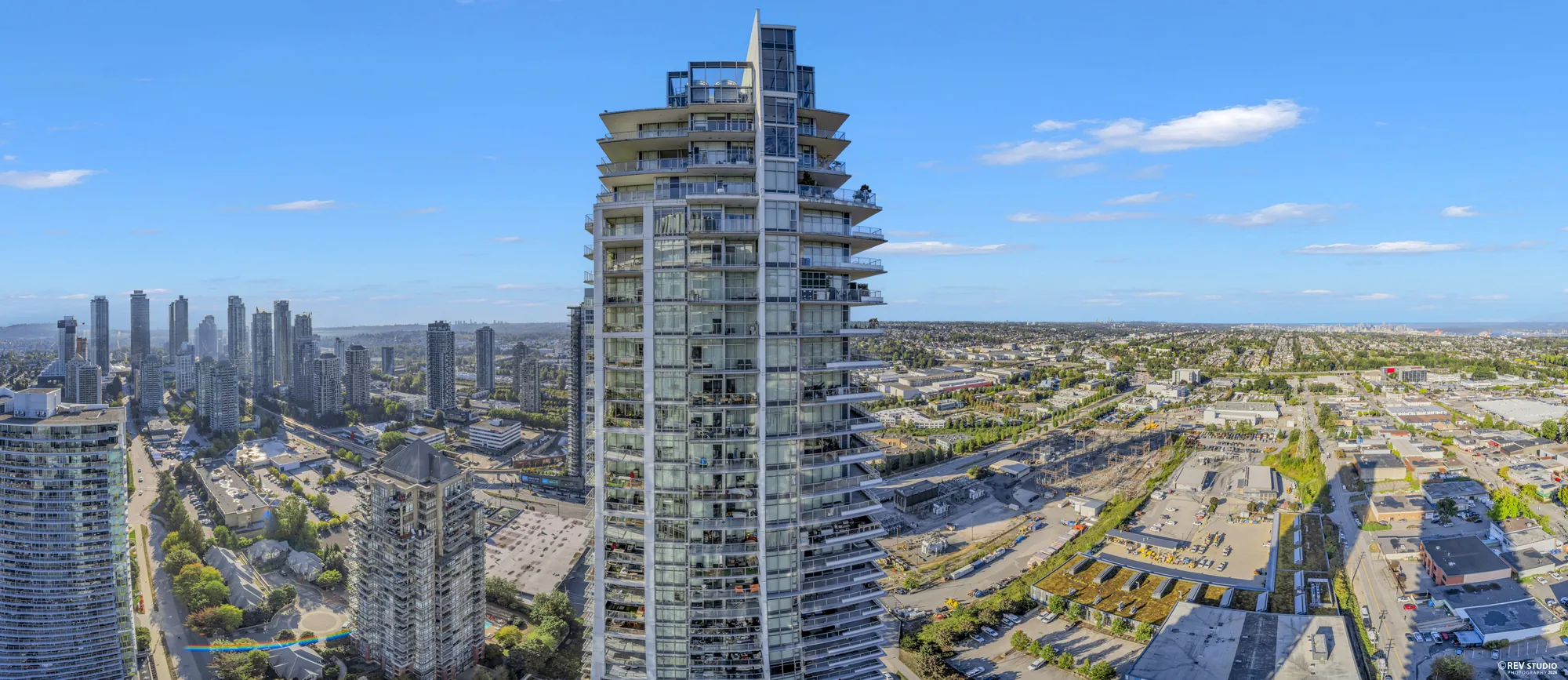 Panorama from the balcony taking in the neighbouring tower, the rail yards and the city beyond